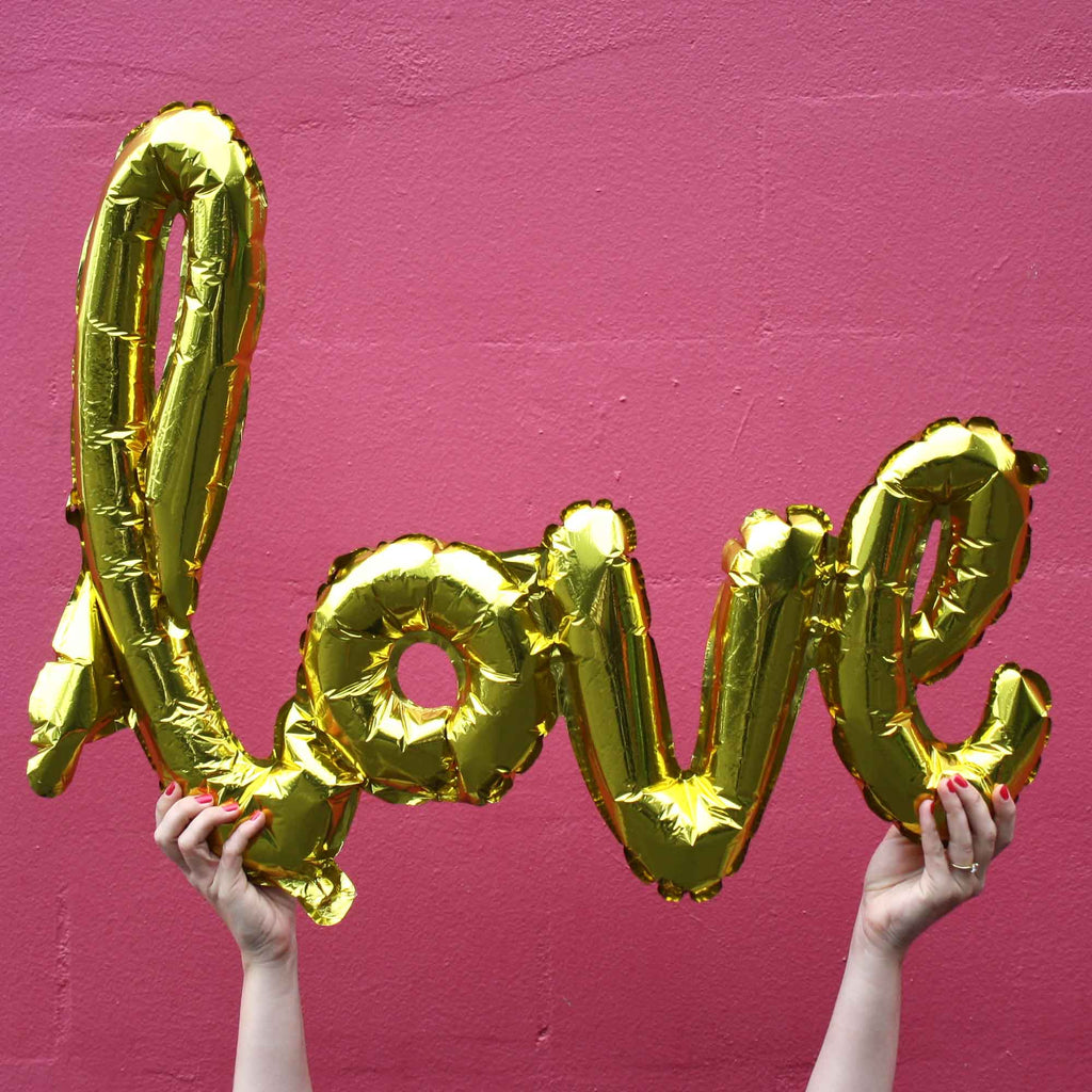 love balloons script in gold engagement party